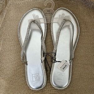 Silver flip flops.